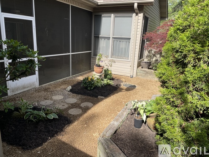 A patio with a stone path and potted plants.