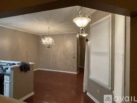 A kitchen area with a dishwasher and a chandelier.