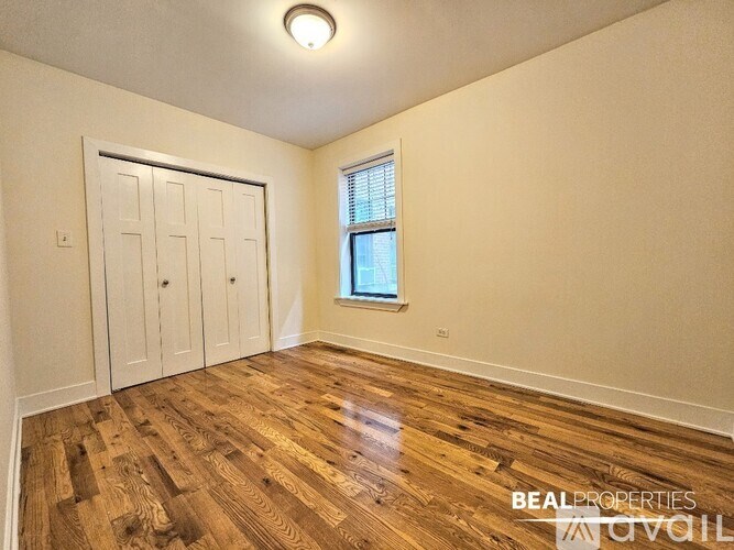 A room with wooden floors and a white door.