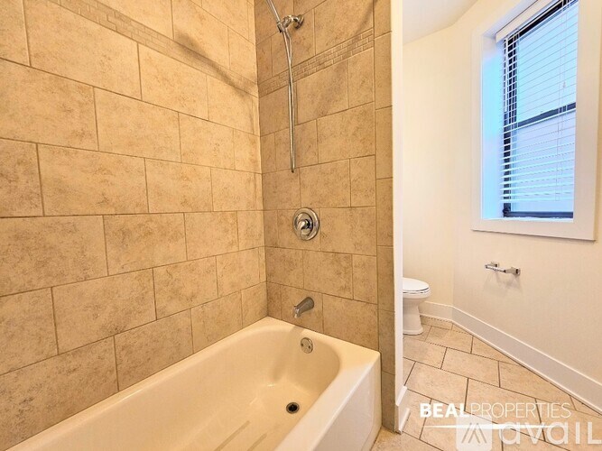 A bathroom with a tiled shower and a bathtub.