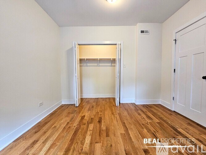 A room with wooden floors and a white door.