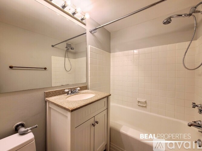 A bathroom with a sink, toilet, and bathtub.