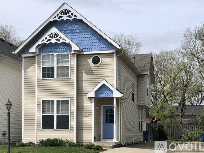 A house with a blue roof and a white door.