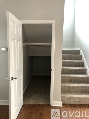 A white door opens to a stairway.