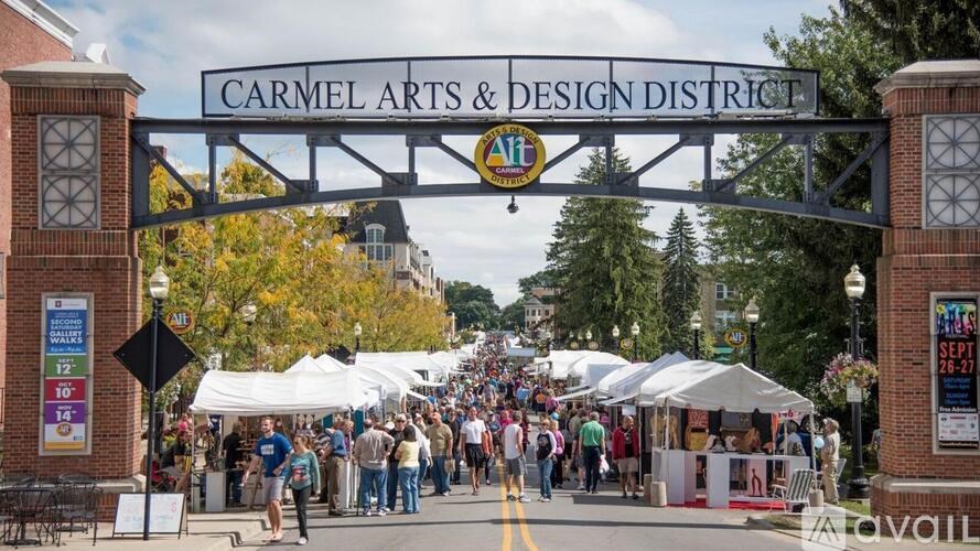 A street scene with a sign that says Carmel Arts & Design District.