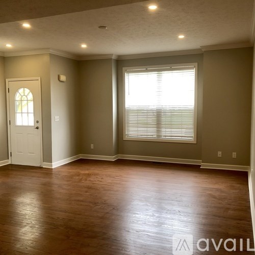 A room with a wooden floor and a white door.