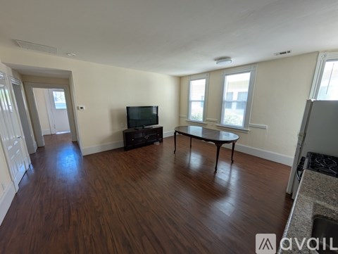 A living room with a television and a coffee table.