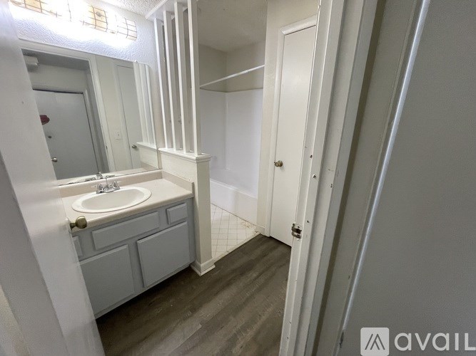 A bathroom with a sink and a mirror.
