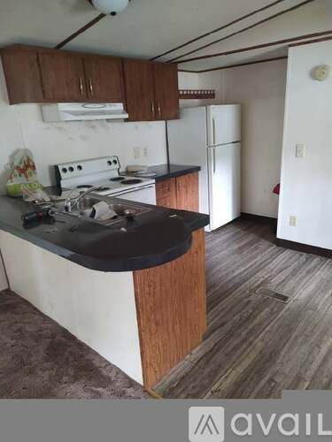 A kitchen with a white stove and a black counter.