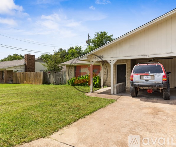A white house with a red door and a sign that says "City Ave 409" is shown with a vehicle parked in front.
