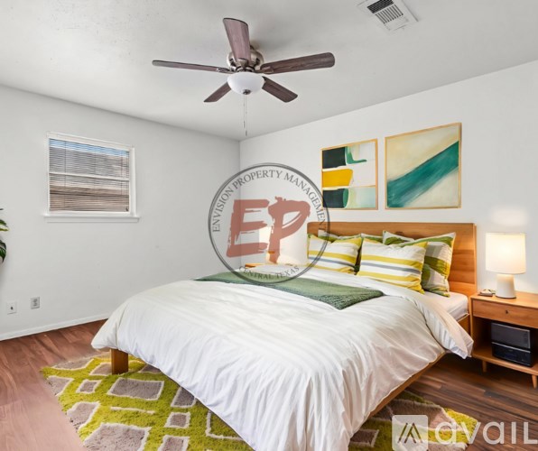 A bedroom with a bed, a ceiling fan, and a wall-mounted sign that reads "EPC".