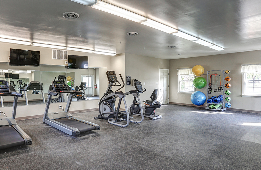 Fitness Center with cardio machines and yoga area.