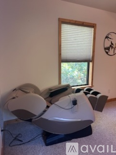 A room with a large window and a wall-mounted speaker.