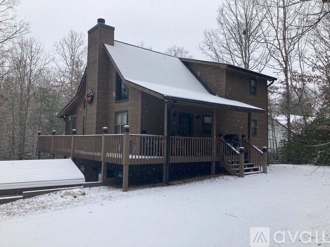 A house with a snow-covered roof and deck.