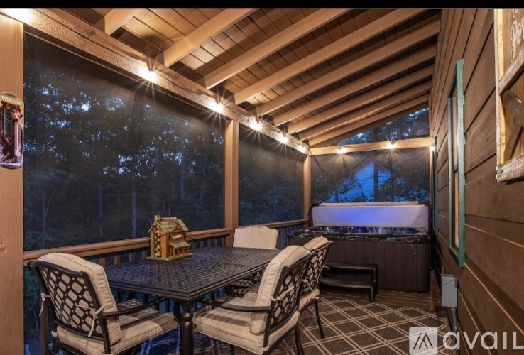 A wooden deck with a table and chairs is available for rent.