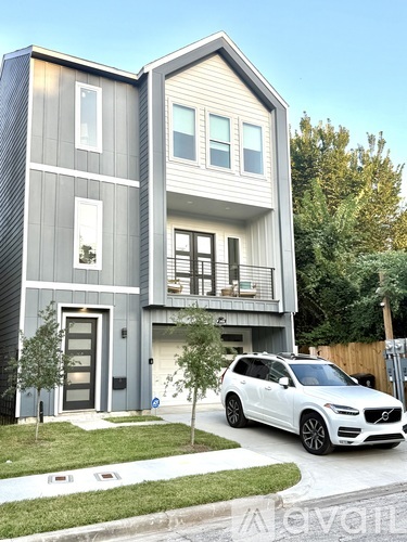 A modern two-story house with a blue exterior and white trim.