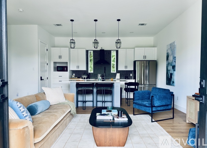 A living room with a grey sofa and a white counter.
