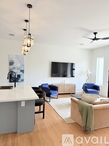 A living room with a grey sofa and a white counter.
