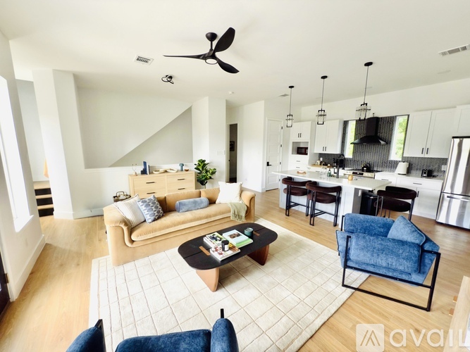 A kitchen with a table and chairs in front of it.