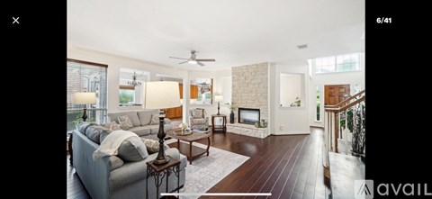 A living room with a grey couch and a coffee table.