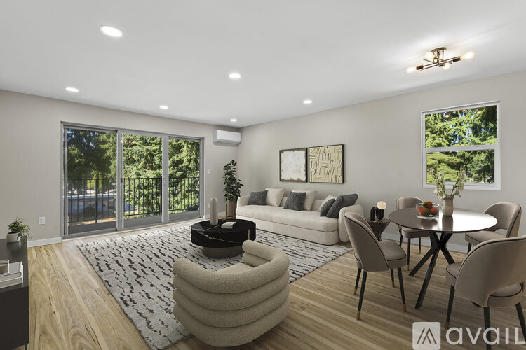 A modern living room with a large window and sliding glass doors.