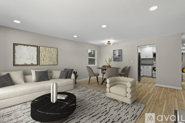 A living room with a white sofa, a coffee table, and a rug.