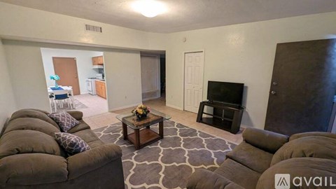 A living room with a brown couch and a coffee table.