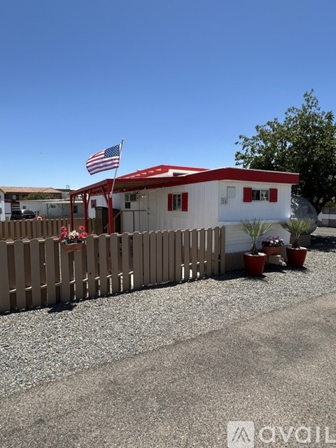 A white building with a red roof and an American flag on top.