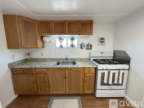 A kitchen with wooden cabinets and a granite countertop.