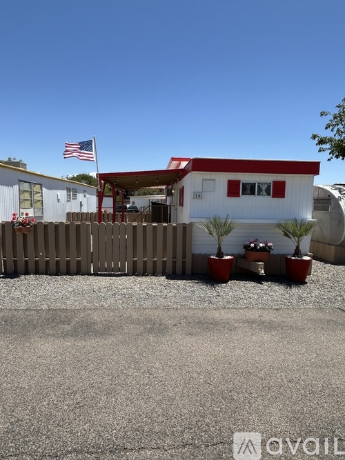 A house with a red roof and a flag on top of it.