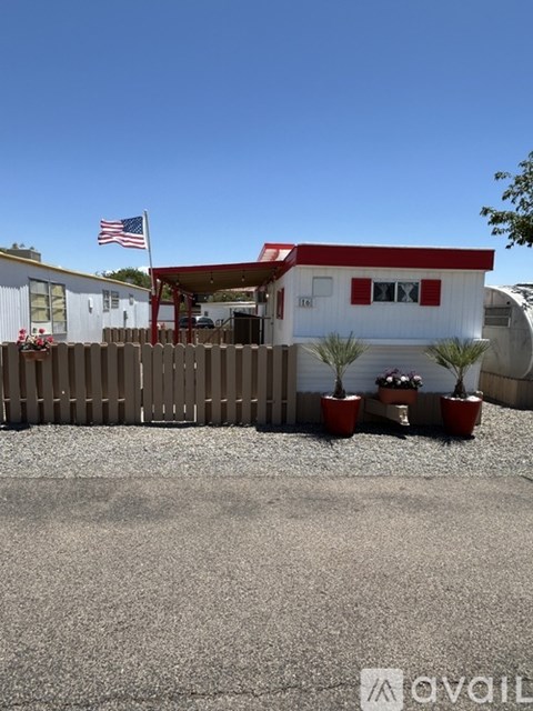A house with a red roof and a flag on top of it.