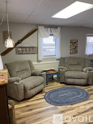 A living room with two chairs and a table.
