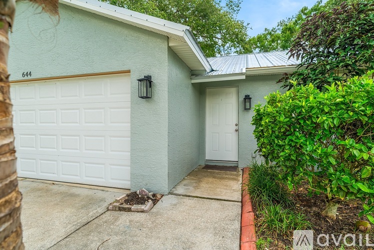 A house with a white garage door and a white door.