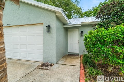 A house with a white garage door and a white door.