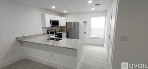 A kitchen with granite countertops and stainless steel appliances.