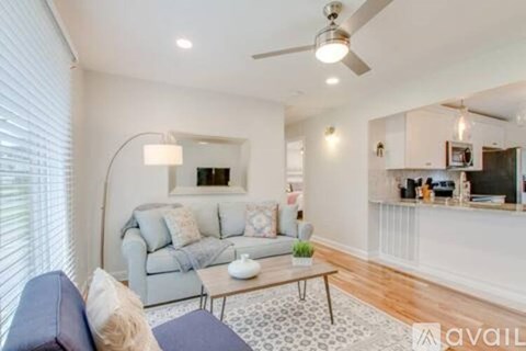 A living room with a grey couch and a coffee table.