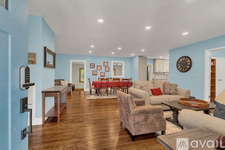 A dining room with a wooden table and chairs.