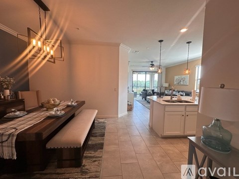 A modern kitchen with a dining table set for two.