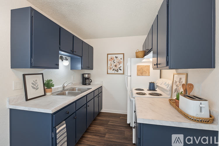 A kitchen with dark blue cabinets and a white countertop.