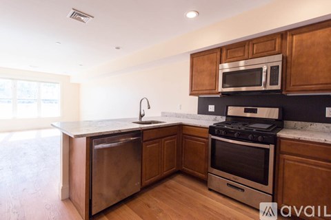 A kitchen with wooden cabinets and stainless steel appliances.