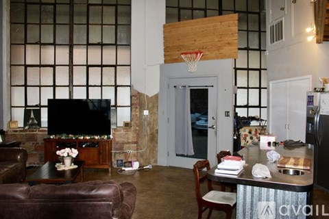 A living room with a television and a dining table.
