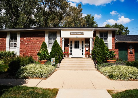 the front of a brick building with a white door