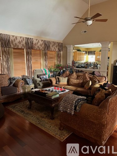 A living room with a brown sofa and a coffee table.
