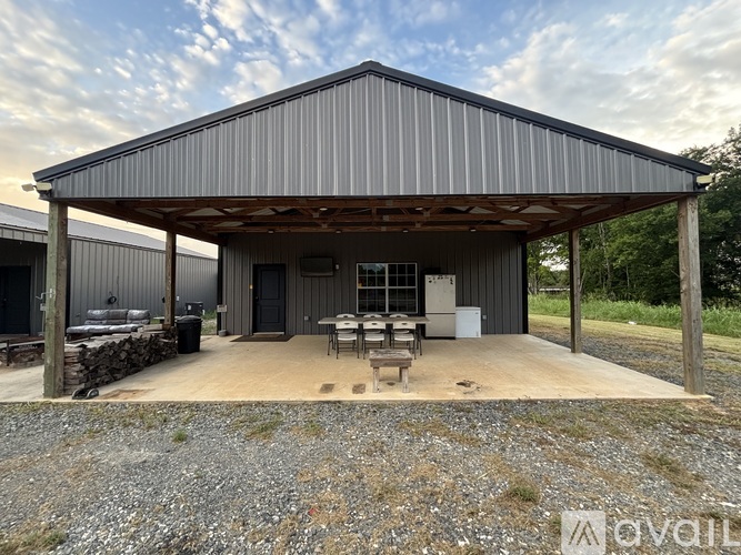 A large metal building with a covered patio area.