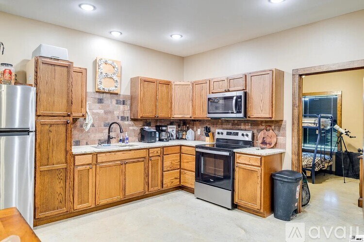 A kitchen with wooden cabinets and stainless steel appliances.