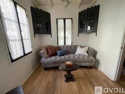 A living room with a grey couch and a coffee table.