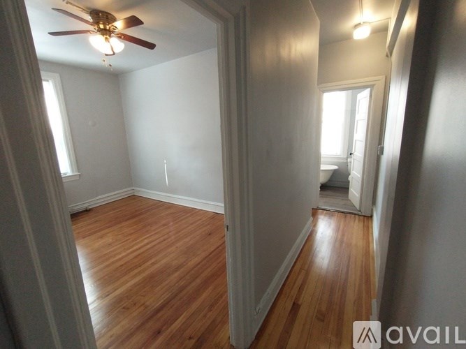 A bathroom with a marble wall and a toilet.
