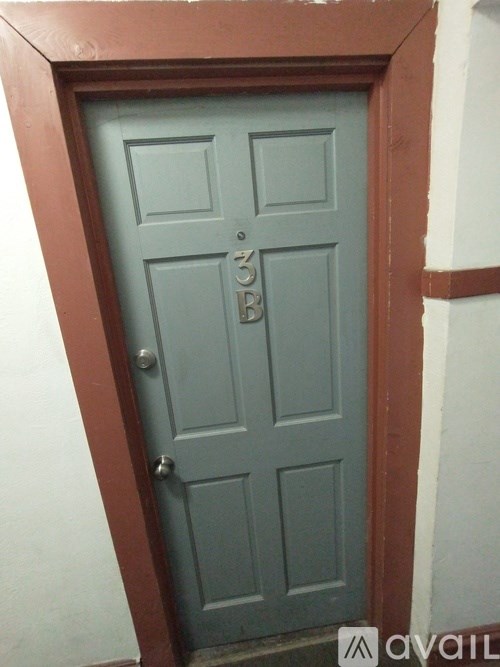 A blue door with a silver handle and a number 3 on it.