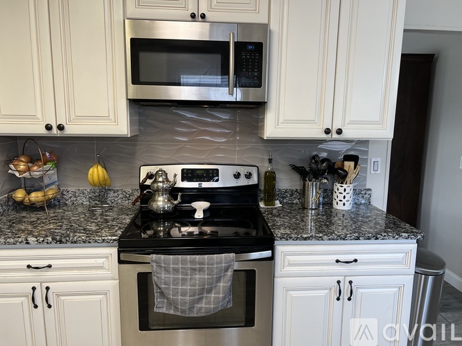 A kitchen with a stove top oven and a microwave above it.