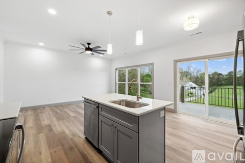 A kitchen with a sink and a fan on the ceiling.